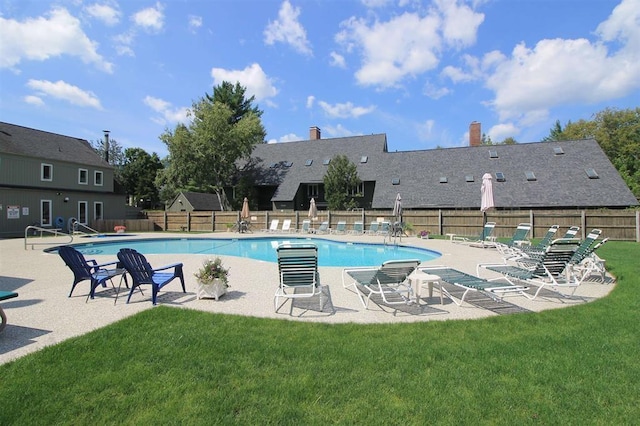 view of swimming pool featuring a yard and a patio