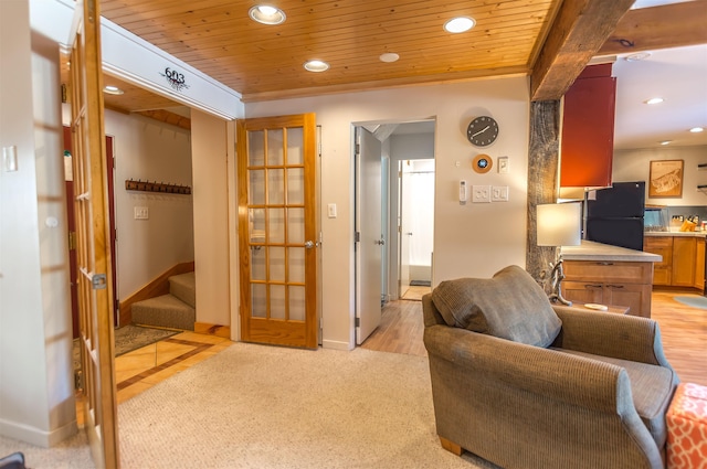 carpeted living room featuring french doors and wood ceiling