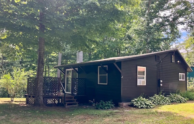 view of side of home featuring a wooden deck