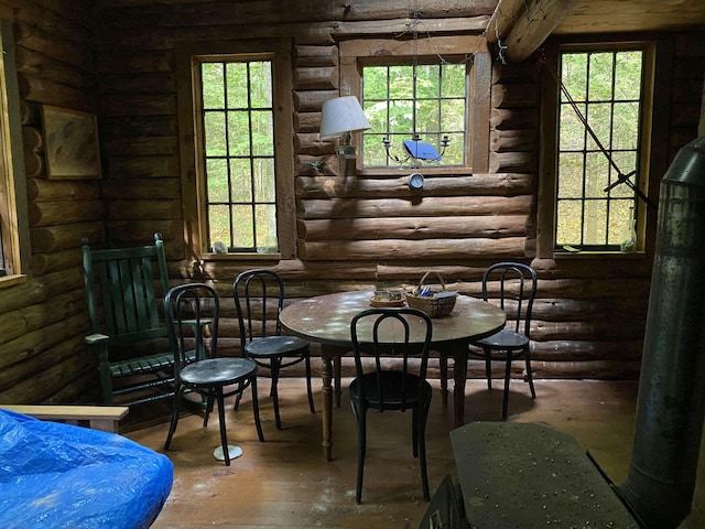 living area featuring log walls and plenty of natural light