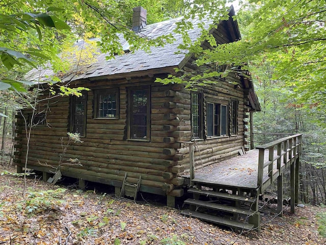 view of property exterior with a deck