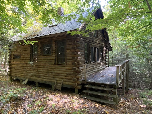 view of home's exterior with a wooden deck