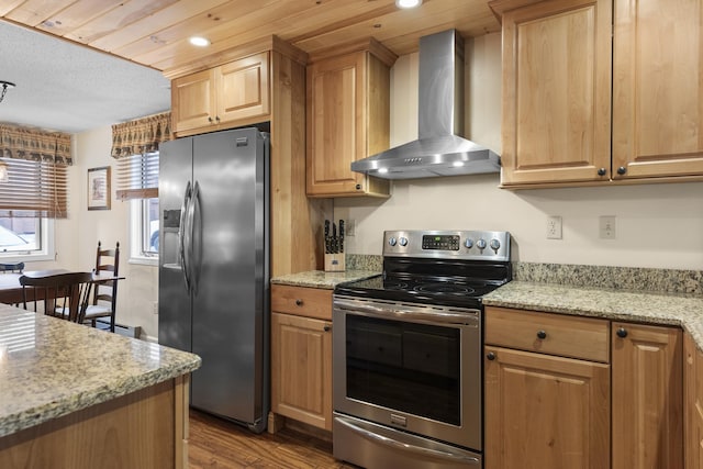 kitchen featuring light stone countertops, appliances with stainless steel finishes, light hardwood / wood-style flooring, and wall chimney exhaust hood