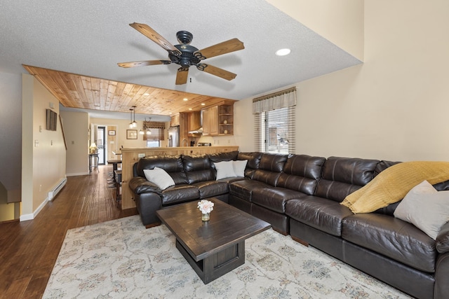 living room featuring ceiling fan, wooden ceiling, a baseboard radiator, a textured ceiling, and hardwood / wood-style flooring