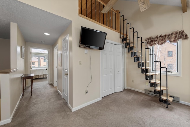 interior space with a wealth of natural light, carpet, and a high ceiling