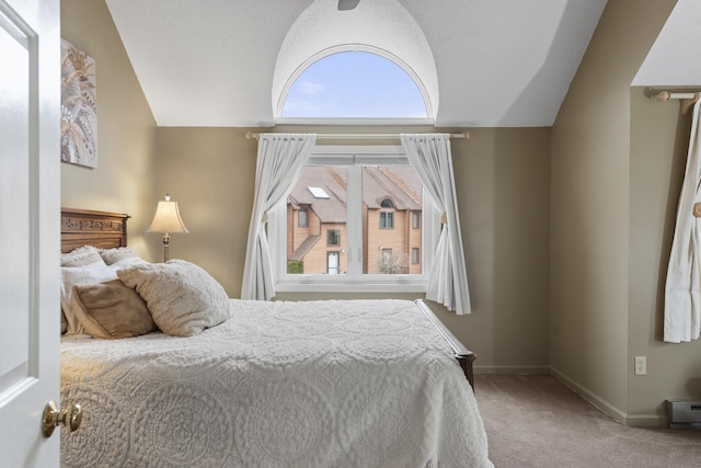 carpeted bedroom featuring vaulted ceiling