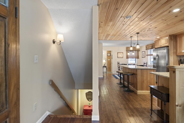 interior space with dark hardwood / wood-style floors and wooden ceiling