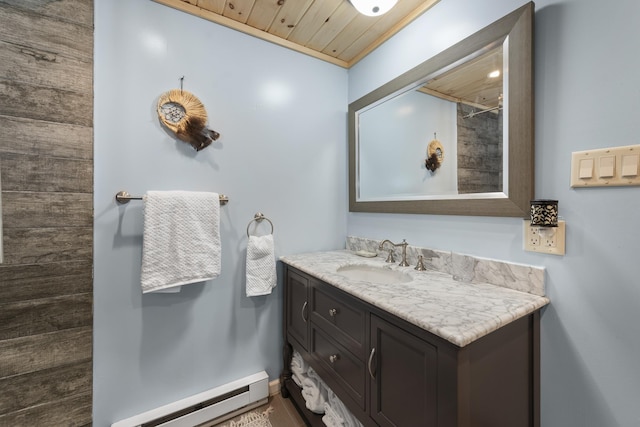 bathroom with vanity, wooden ceiling, ornamental molding, and a baseboard heating unit