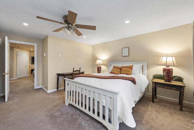 bedroom with ceiling fan, light carpet, and a textured ceiling