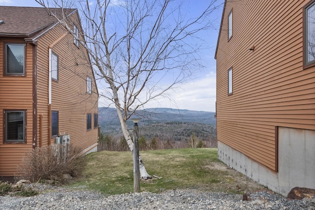 view of side of home with a mountain view