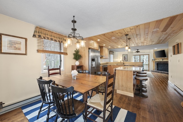 dining room featuring dark hardwood / wood-style floors, a baseboard radiator, ceiling fan, and wood ceiling