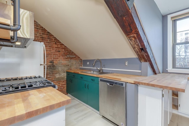 kitchen featuring sink, butcher block countertops, brick wall, and dishwasher