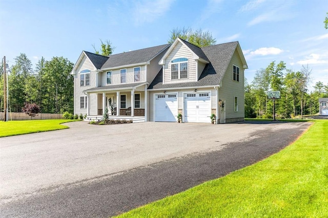 view of front facade featuring a front yard, a porch, and a garage