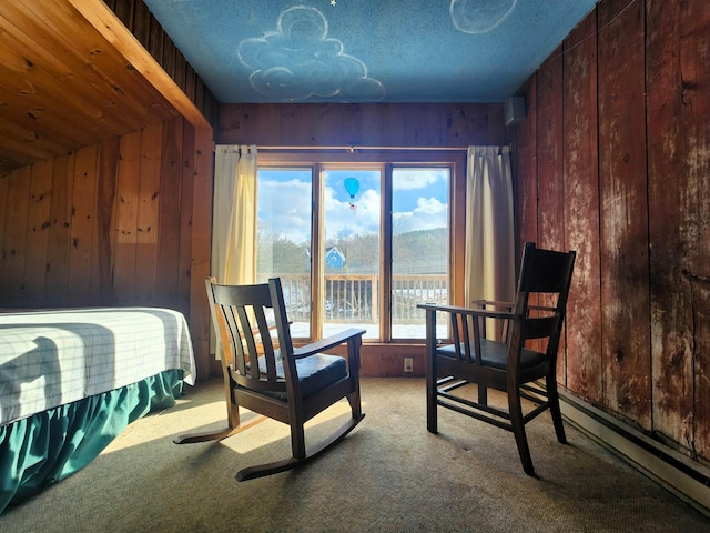 bedroom featuring carpet, vaulted ceiling, and wooden walls