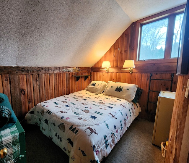 carpeted bedroom with wood walls, a textured ceiling, and vaulted ceiling