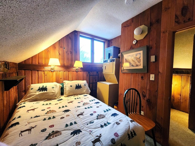 carpeted bedroom with a textured ceiling, wooden walls, and lofted ceiling