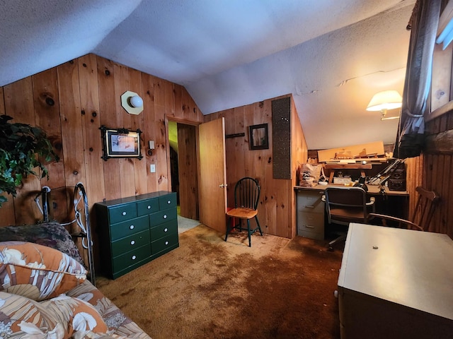 bedroom featuring carpet flooring, a textured ceiling, vaulted ceiling, and wooden walls