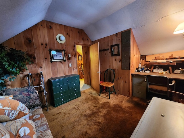 carpeted bedroom with wood walls, a textured ceiling, and vaulted ceiling