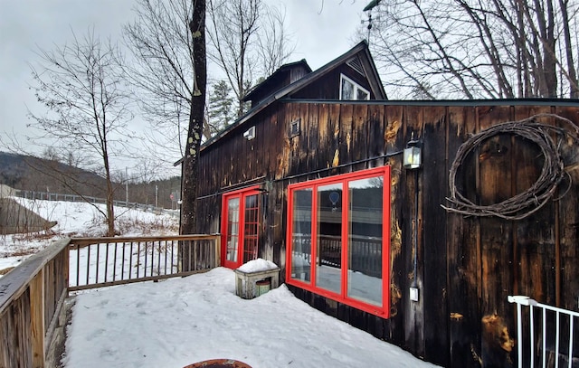 snow covered deck featuring a mountain view