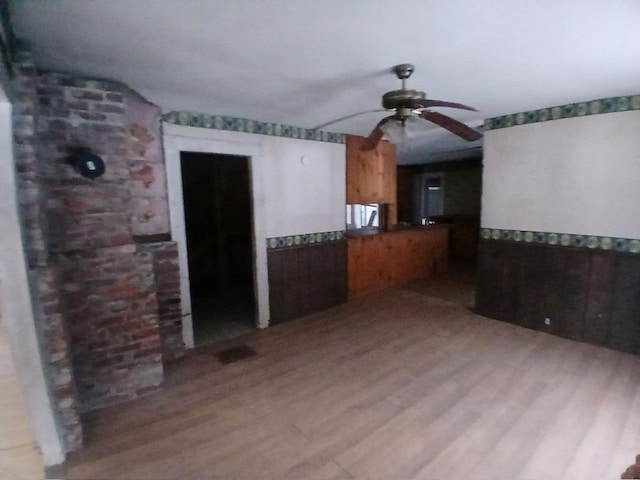 spare room with ceiling fan and light wood-type flooring