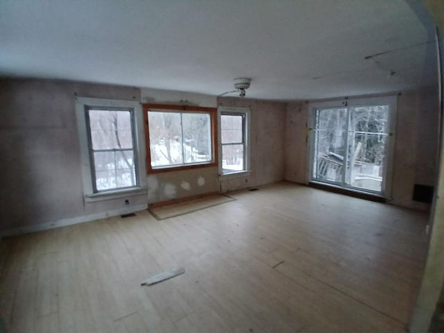 unfurnished room with hardwood / wood-style flooring