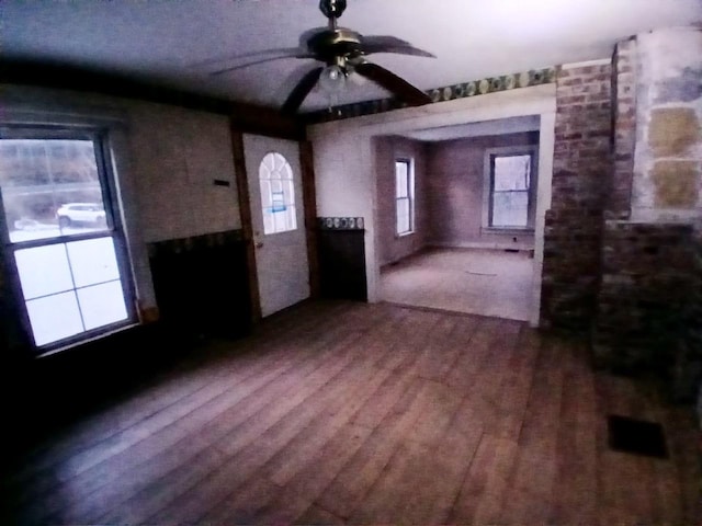 interior space with ceiling fan and wood-type flooring