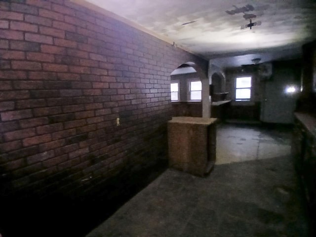 basement featuring brick wall