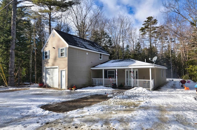 view of front property featuring covered porch and a garage