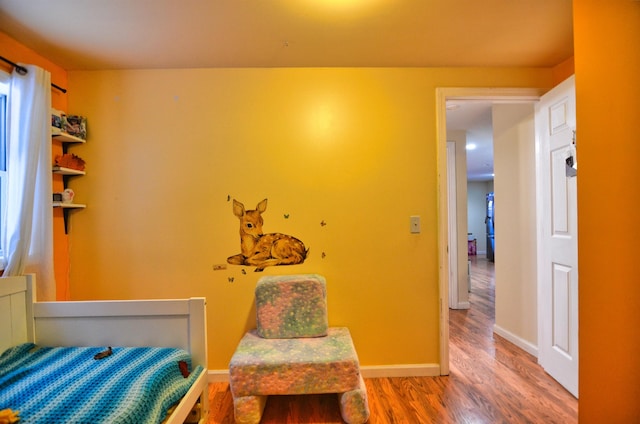 bedroom with wood-type flooring
