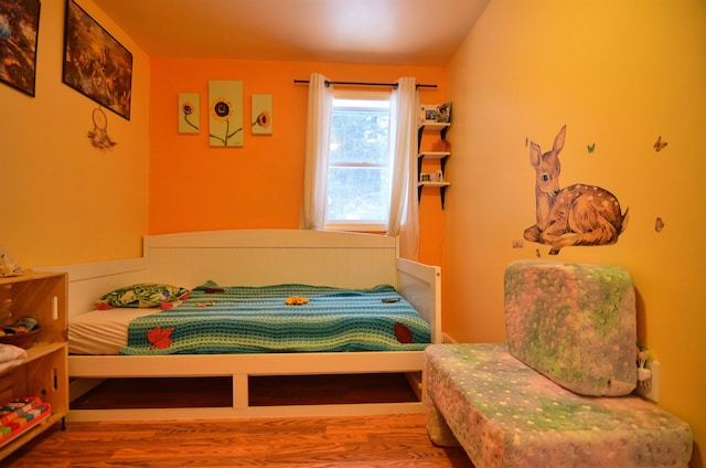 bedroom with hardwood / wood-style floors