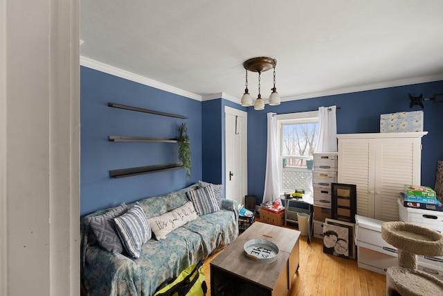 living room with light hardwood / wood-style floors and ornamental molding