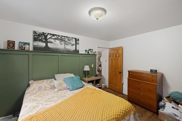 bedroom with dark hardwood / wood-style flooring