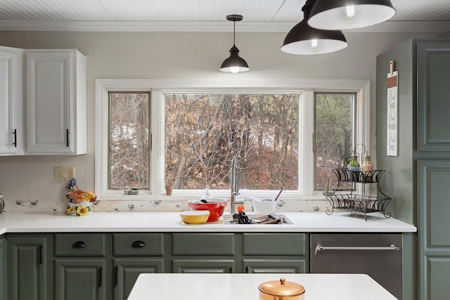 kitchen with decorative light fixtures, white cabinetry, and crown molding