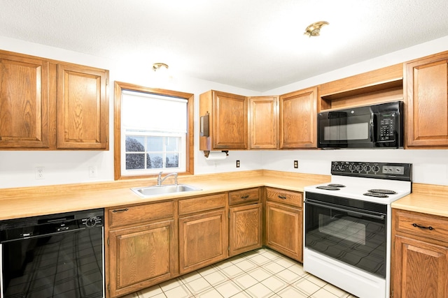 kitchen with black appliances, light tile patterned floors, and sink