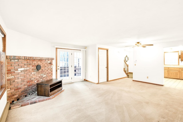 unfurnished living room featuring ceiling fan, french doors, and light carpet