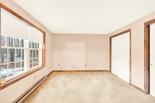 unfurnished bedroom with a baseboard radiator, a closet, and light colored carpet