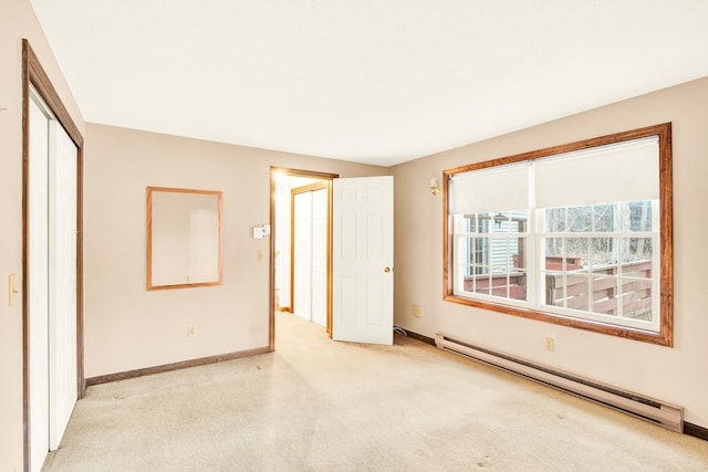 unfurnished bedroom featuring baseboard heating and a closet