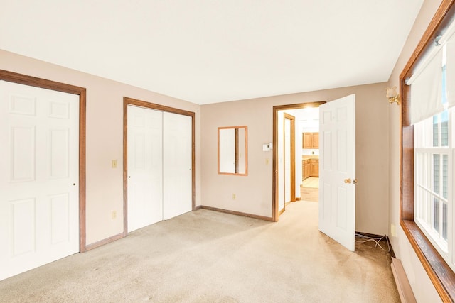 unfurnished bedroom with light colored carpet