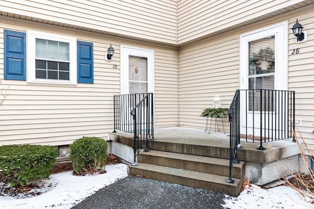 view of snow covered property entrance