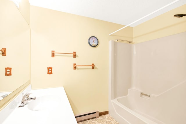 bathroom with tile patterned floors, sink, bathtub / shower combination, and a baseboard heating unit