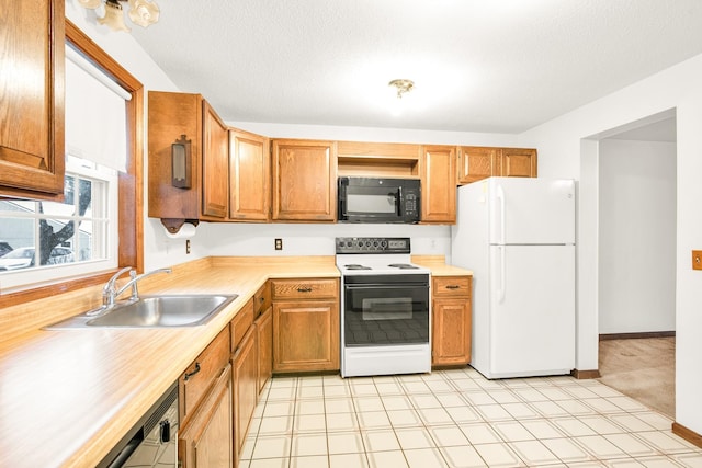 kitchen with light colored carpet, white appliances, and sink