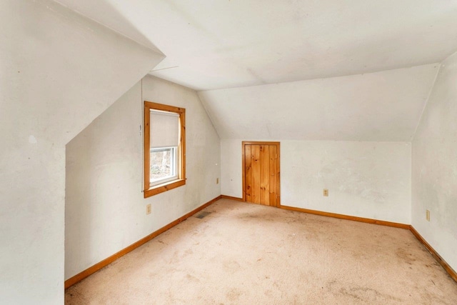 bonus room with lofted ceiling and carpet