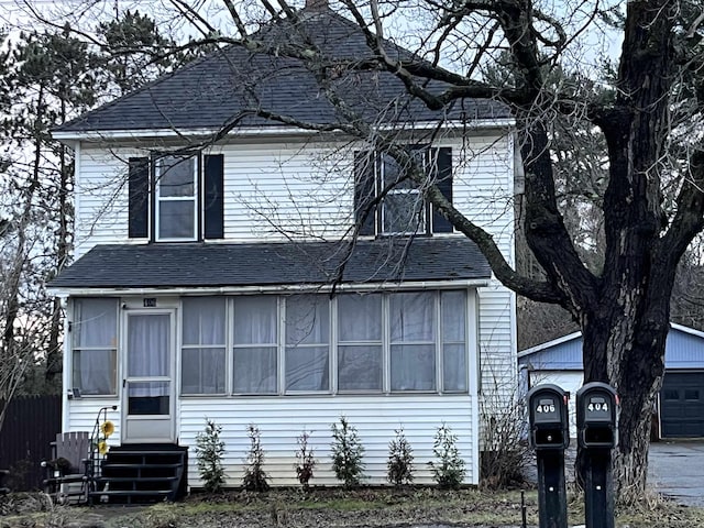 view of front of house with a garage and an outdoor structure