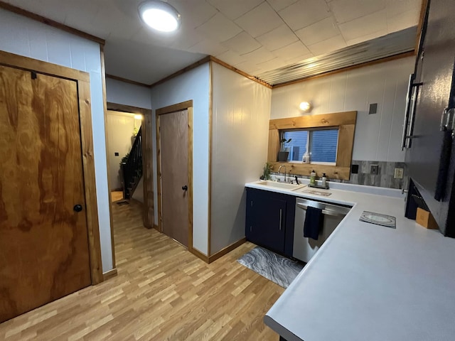 kitchen featuring crown molding, dishwasher, light hardwood / wood-style flooring, and sink