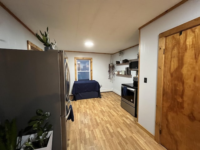 kitchen with stainless steel appliances, white cabinetry, and light hardwood / wood-style flooring