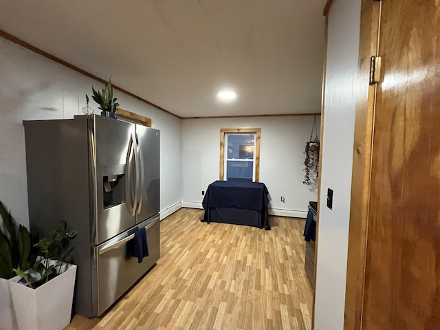 kitchen featuring stainless steel fridge with ice dispenser, crown molding, baseboard heating, and light hardwood / wood-style flooring