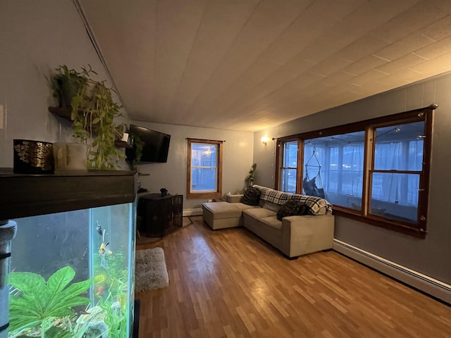 living room featuring wood-type flooring and baseboard heating