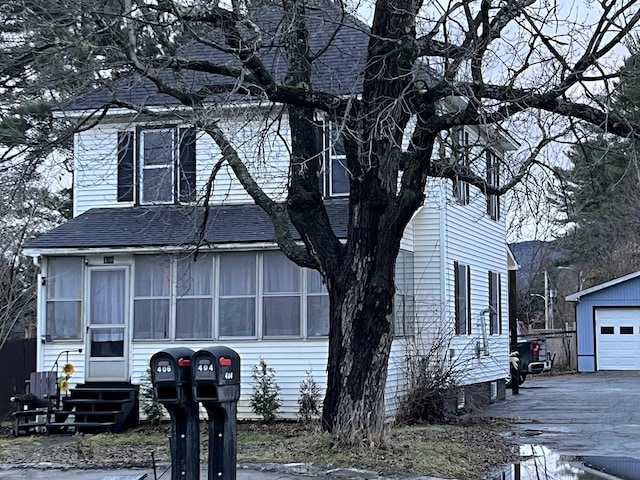 view of front facade featuring an outbuilding and a garage