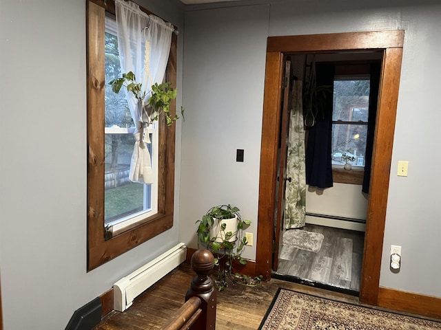 doorway with wood-type flooring and baseboard heating