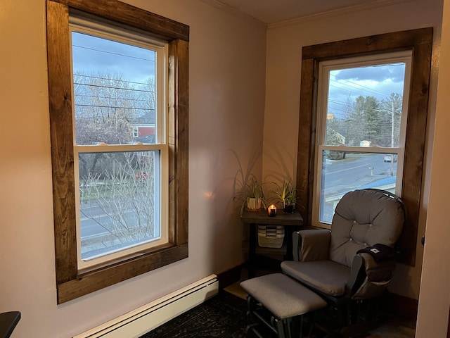 sitting room featuring plenty of natural light, ornamental molding, and a baseboard radiator